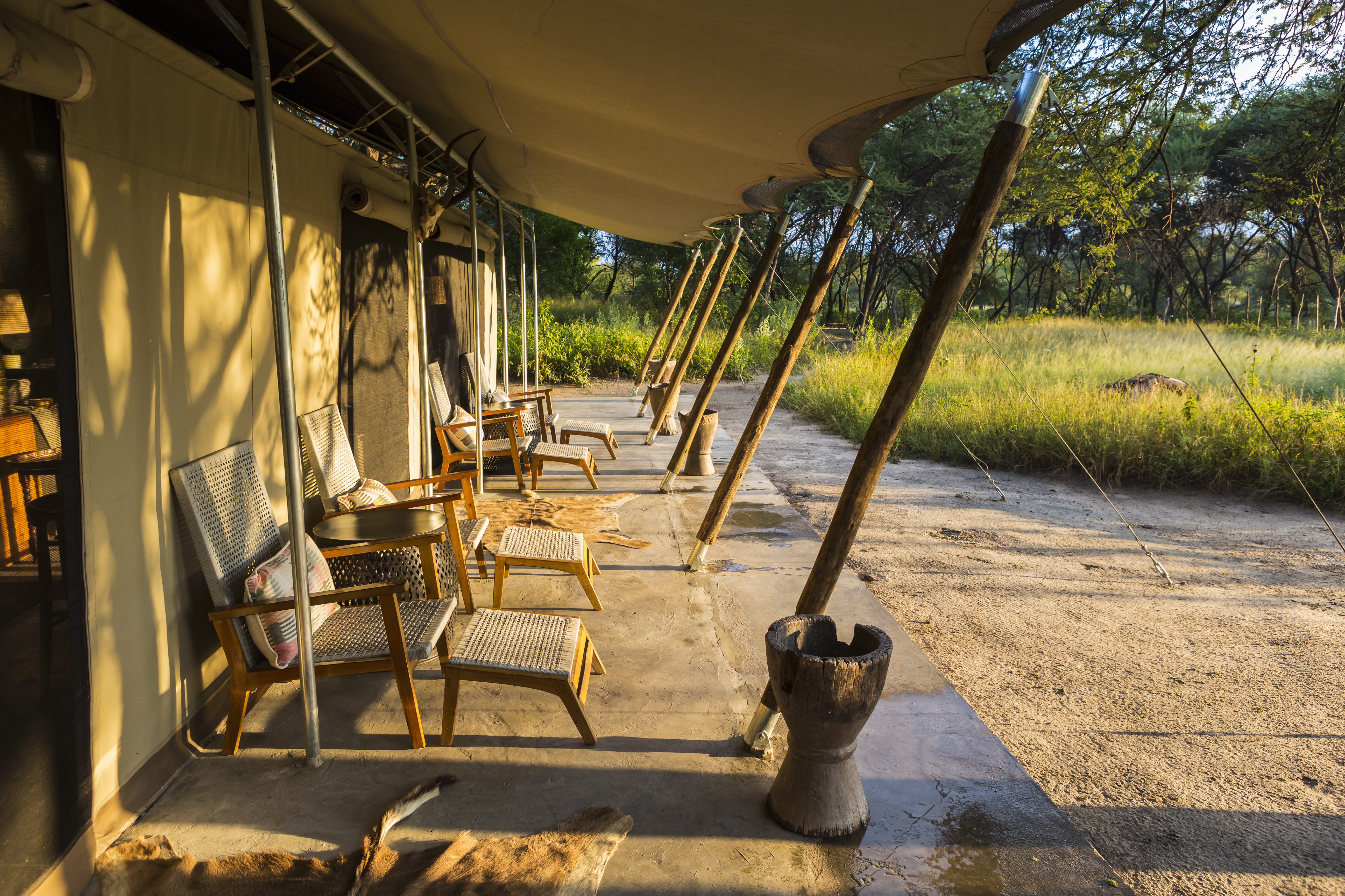 Elegantly designed luxury tented camp in Tanzania's Serengeti with open canvas walls, private deck and panoramic bush views — a defining element of the best safari in Tanzania