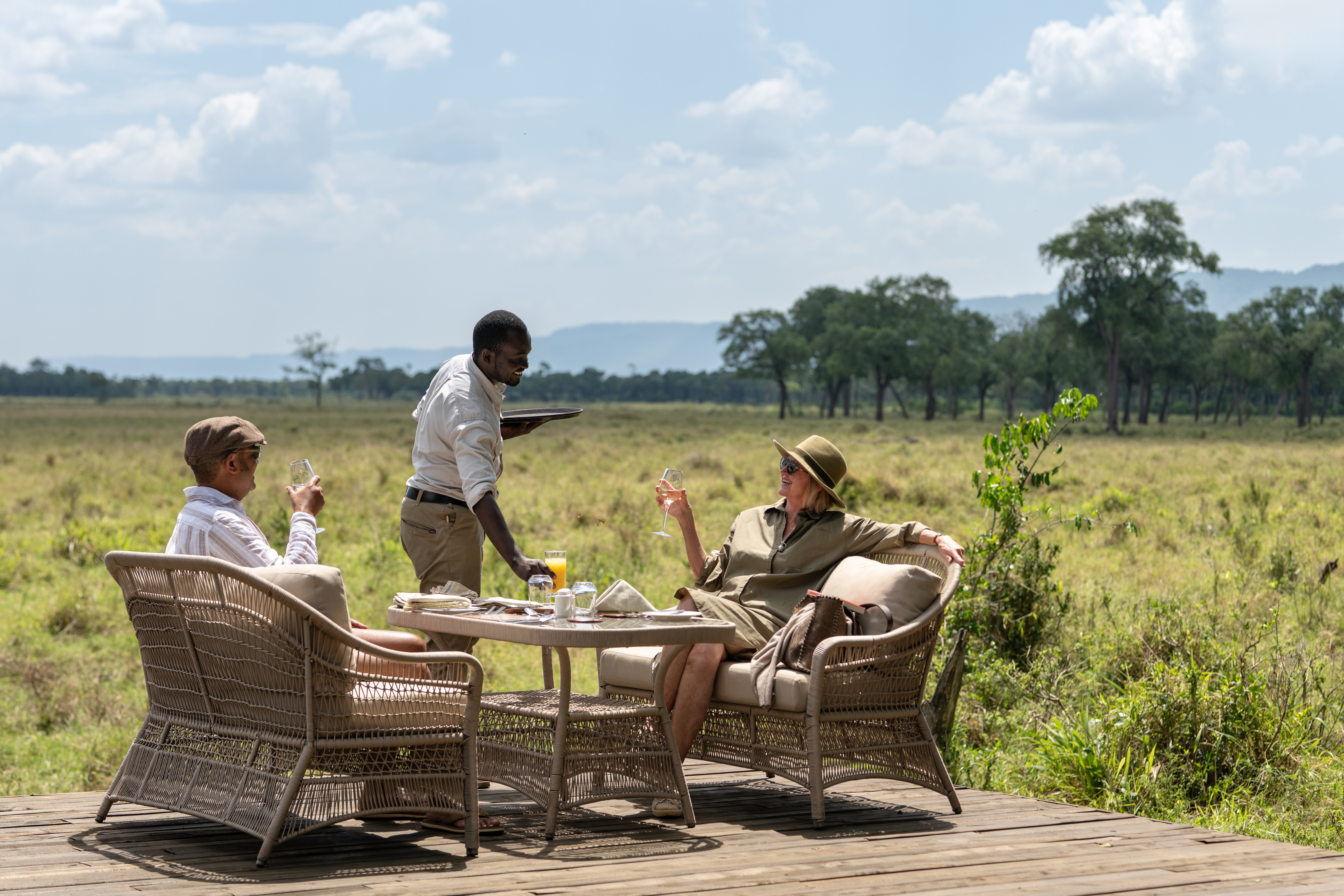 Luxury safari guests in a private vehicle observing lions safely in Tanzania's Serengeti National Park
