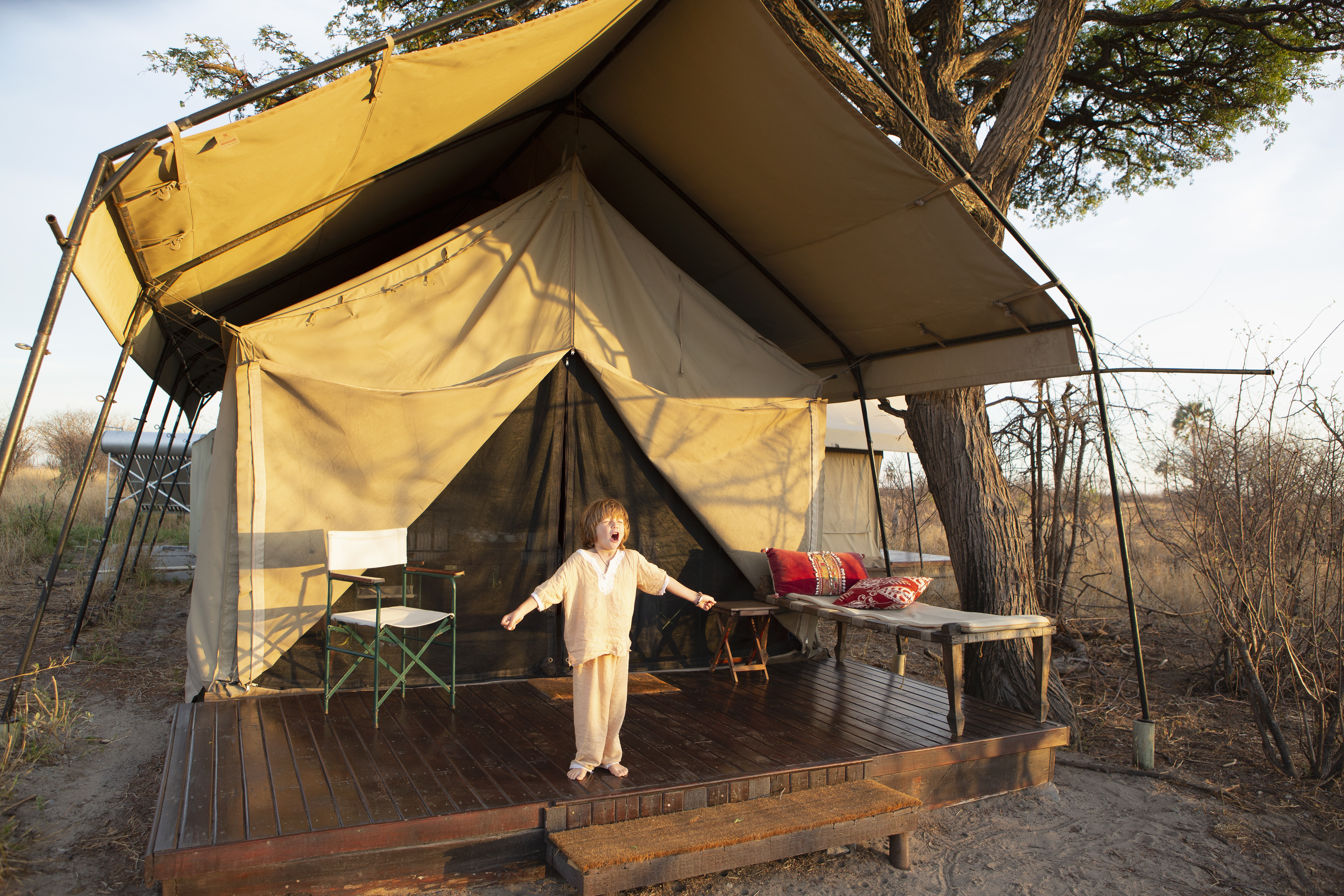 Elegantly set private dining table in the bush at a luxury Tanzania exclusive-use camp — the kind of bespoke experience that defines private safari travel