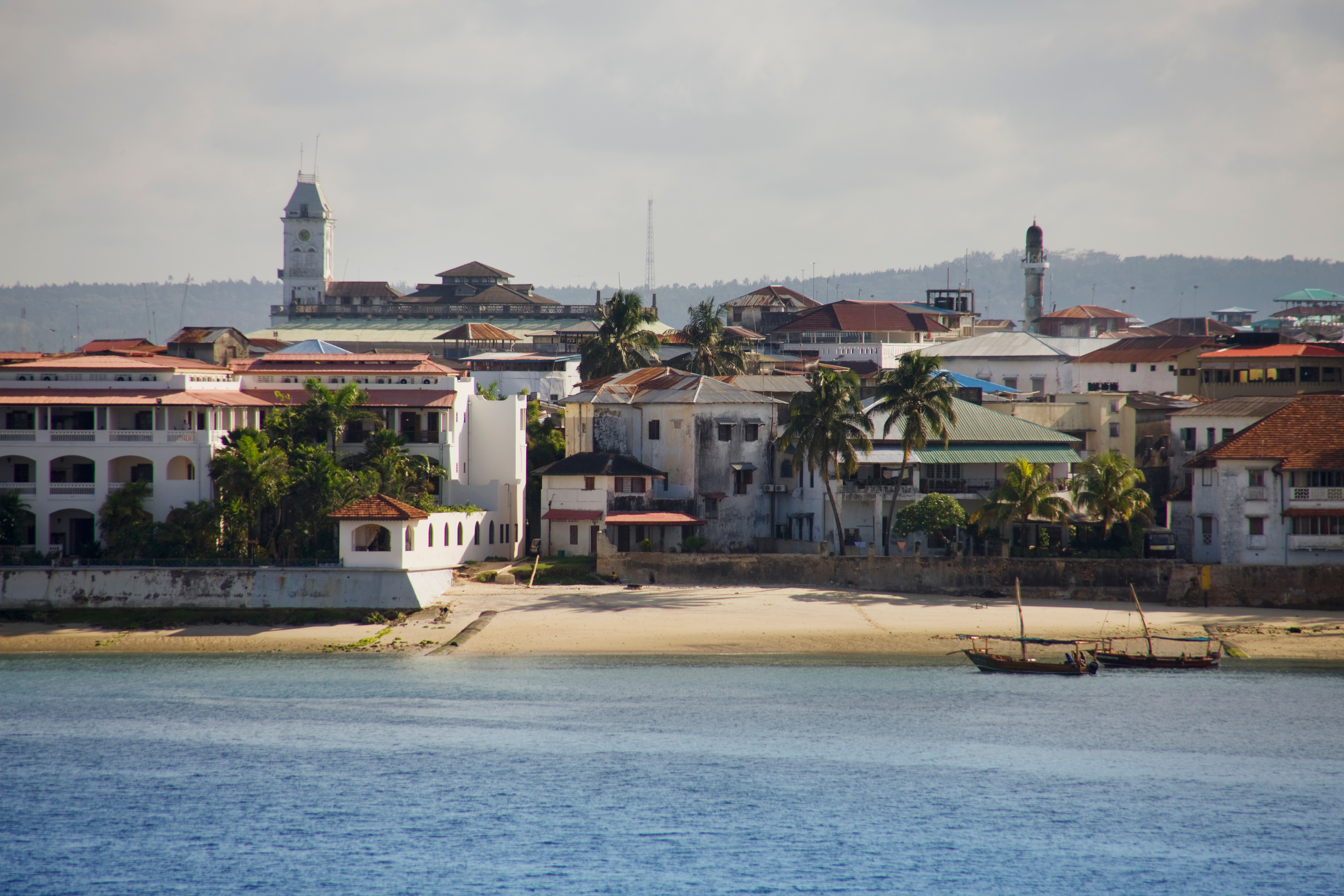 Stone Town Zanzibar's historic waterfront and carved doorways at golden hour — the cultural dimension of the Tanzania safari and Zanzibar combination