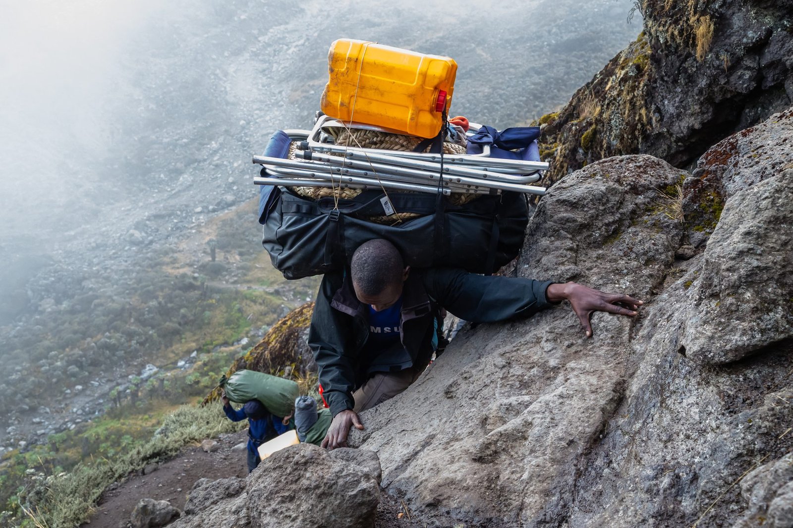 A porter climbing the Barranco Wall on the Umbwe Route